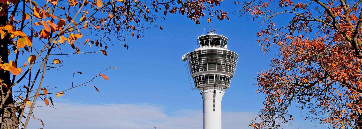 Munich Airport Tower The Munich Airport Tower against a blue sky with trees in autumn colors
