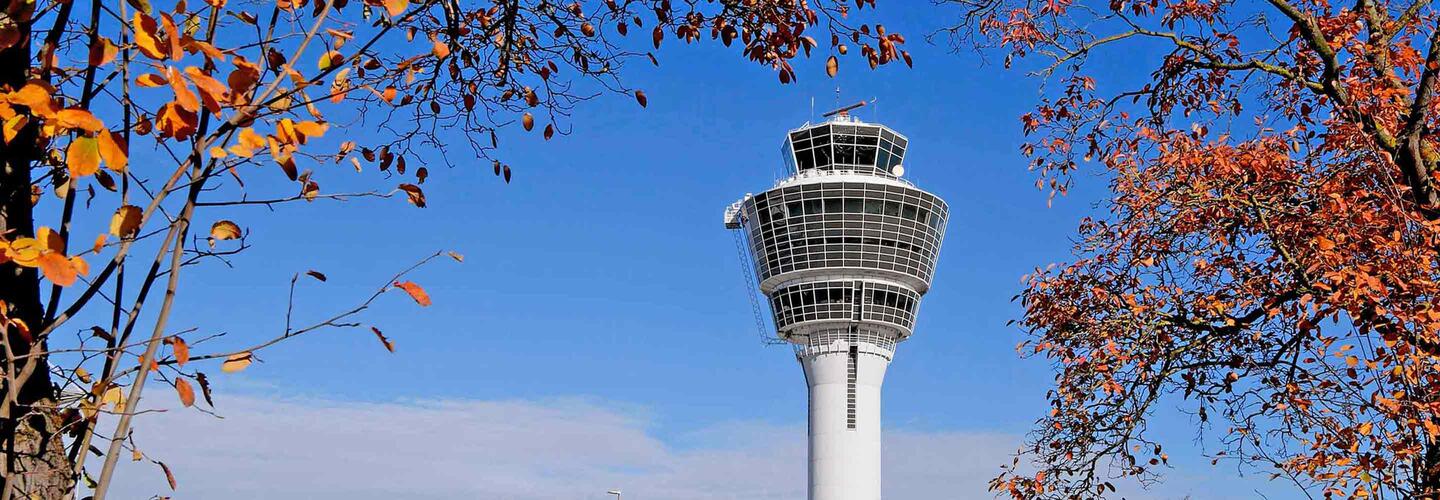 Munich Airport Tower The Munich Airport Tower against a blue sky with trees in autumn colors